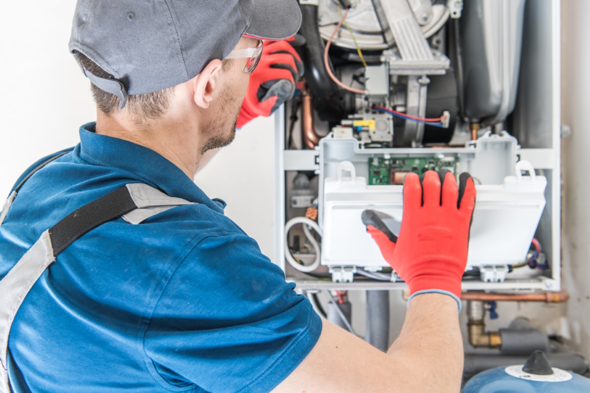 Técnico experto reparando una caldera Cointra eléctrica en Griñón